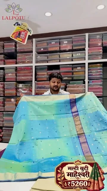 Blue and green Maheshwari saree displayed inside Lalpotu Collection
