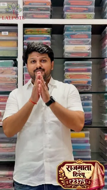 A presenter among saree displays inside Lalpotu Collection